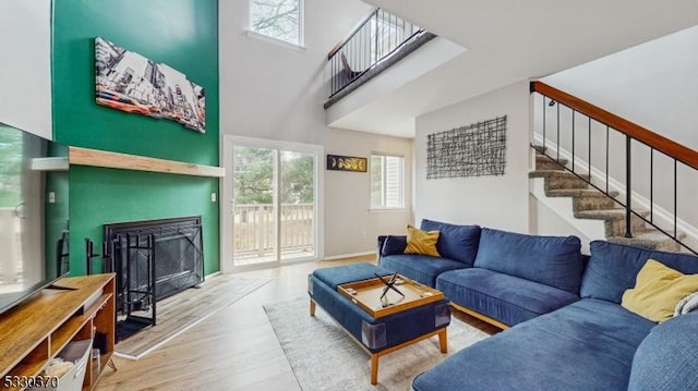 living room with hardwood / wood-style floors and a high ceiling