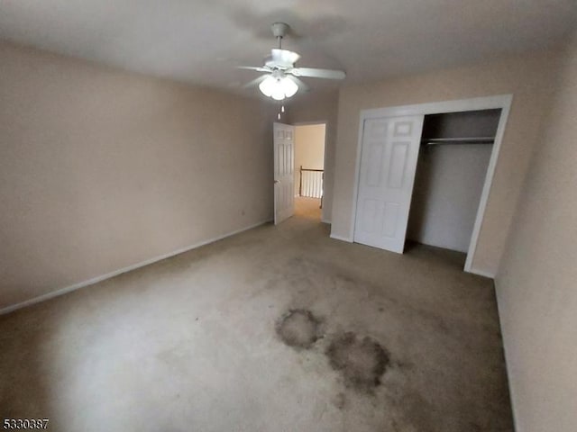 unfurnished bedroom featuring carpet, a closet, and ceiling fan