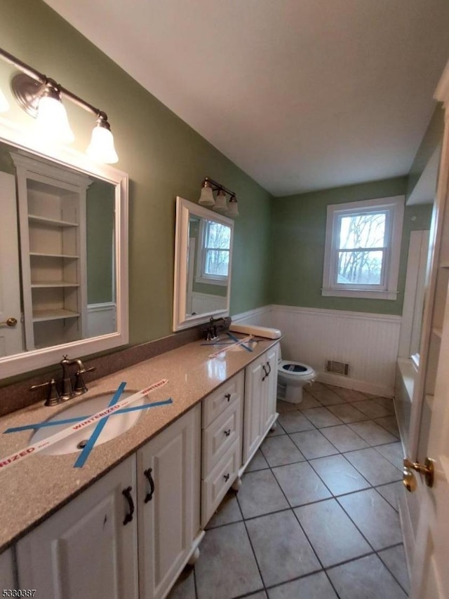 bathroom with tile patterned floors, vanity, and toilet