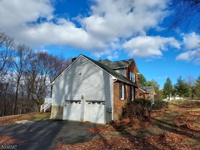 view of side of property with a garage