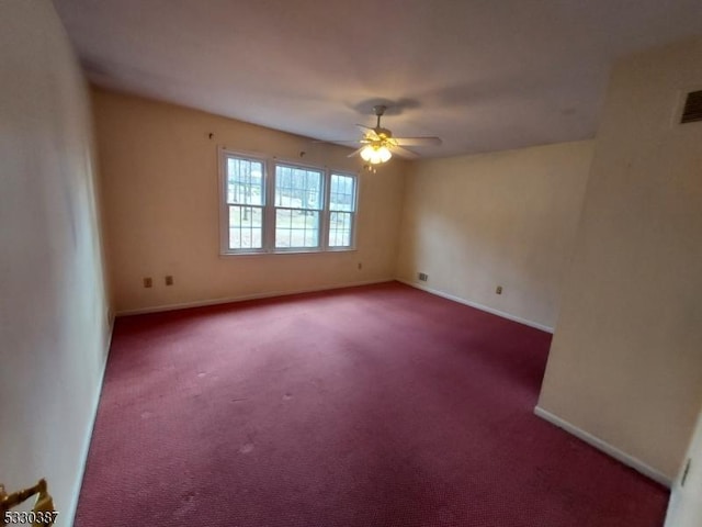 carpeted spare room with ceiling fan