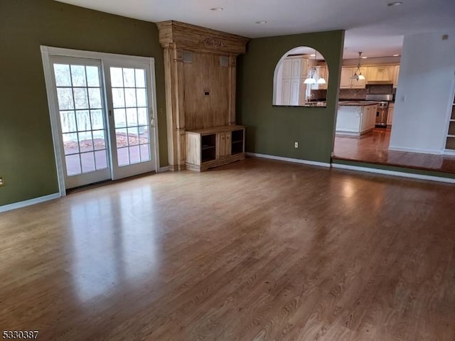 unfurnished living room featuring hardwood / wood-style flooring