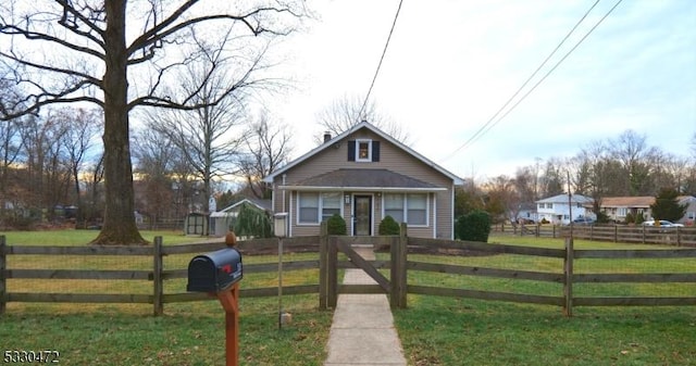 bungalow-style house with a front lawn