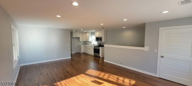 unfurnished living room featuring dark hardwood / wood-style flooring