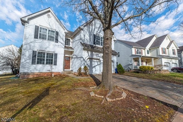 view of front of property featuring a garage and a front lawn