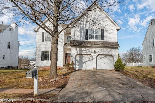 front facade with a front yard and a garage