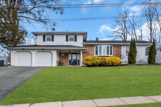 view of front of property with a garage and a front lawn