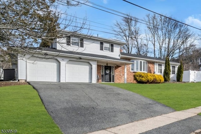 view of front of house featuring a front yard and a garage