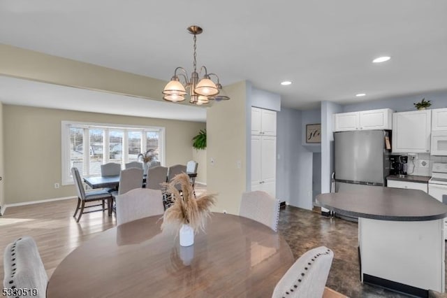 dining area featuring wood-type flooring and a chandelier