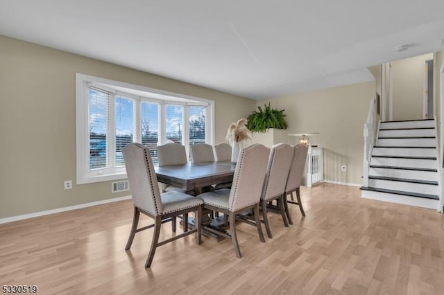 dining space with light hardwood / wood-style flooring