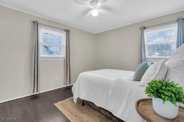 bedroom with dark wood-type flooring and ceiling fan