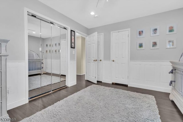 bedroom with two closets and dark wood-type flooring