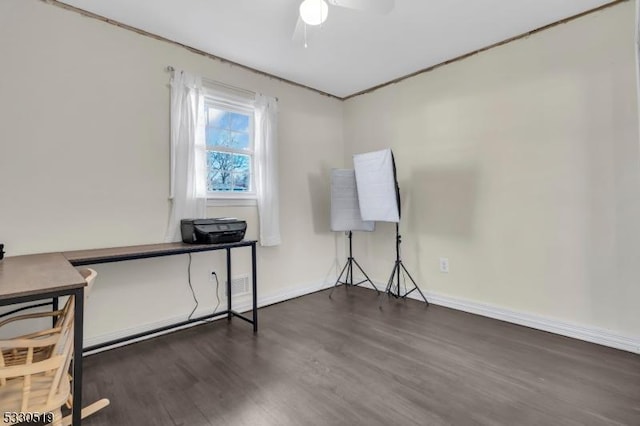 interior space with ceiling fan and dark hardwood / wood-style floors