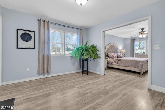 bedroom with ceiling fan and light hardwood / wood-style flooring