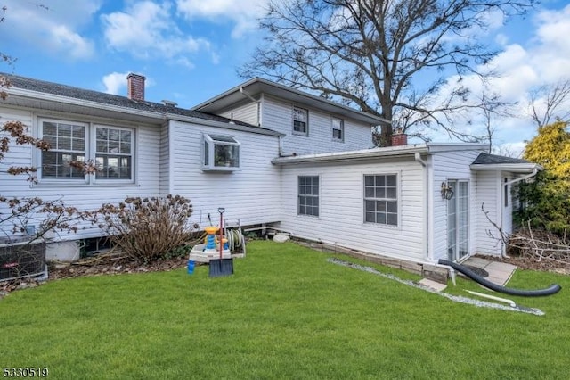 rear view of house with a yard