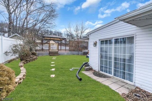 view of yard with a wooden deck and a gazebo