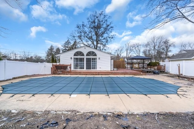 view of swimming pool with a deck, an outbuilding, a patio area, and a gazebo