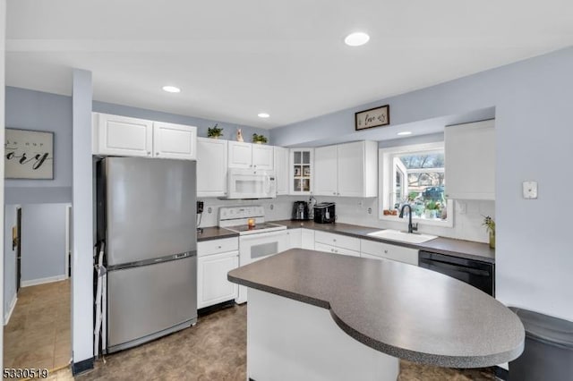 kitchen with white appliances, tasteful backsplash, white cabinetry, and sink