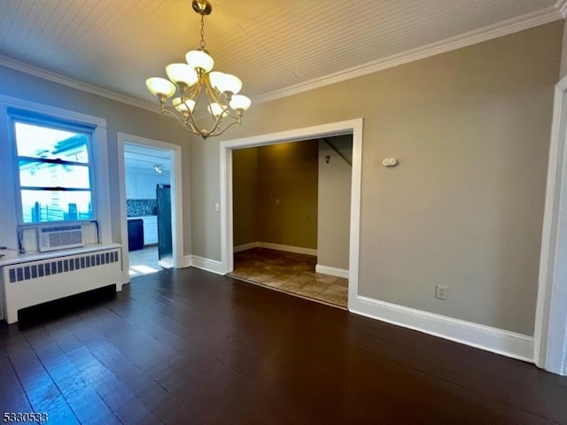 spare room with dark hardwood / wood-style flooring, radiator heating unit, ornamental molding, and an inviting chandelier