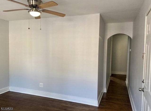 spare room with ceiling fan and dark hardwood / wood-style flooring