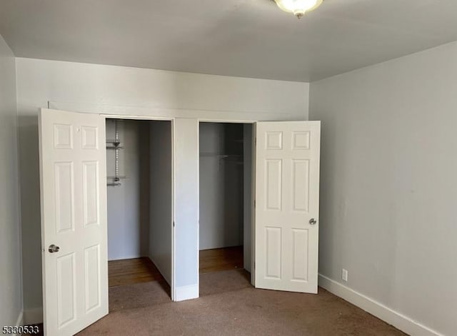 unfurnished bedroom with carpet flooring and a closet