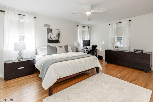 bedroom with ceiling fan and light hardwood / wood-style floors