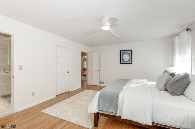 bedroom featuring hardwood / wood-style floors, connected bathroom, and ceiling fan