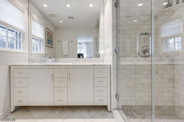 bathroom featuring vanity and a shower with shower door