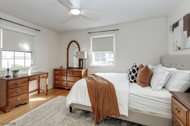 bedroom with ceiling fan and light hardwood / wood-style floors