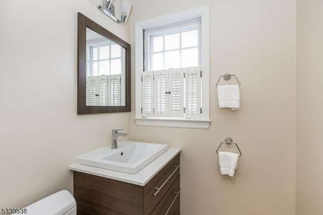 bathroom featuring vanity and toilet