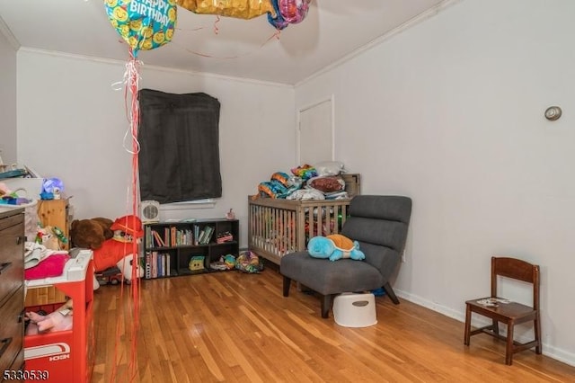 interior space featuring hardwood / wood-style floors and crown molding