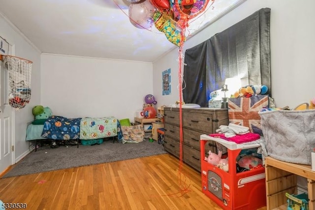 playroom featuring hardwood / wood-style floors and ornamental molding