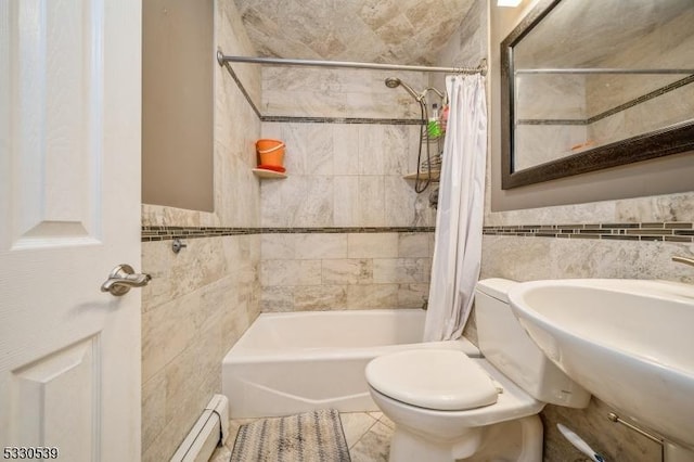 full bathroom featuring shower / bath combination with curtain, tile patterned floors, baseboard heating, sink, and tile walls