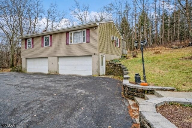 view of property exterior with a garage and a yard