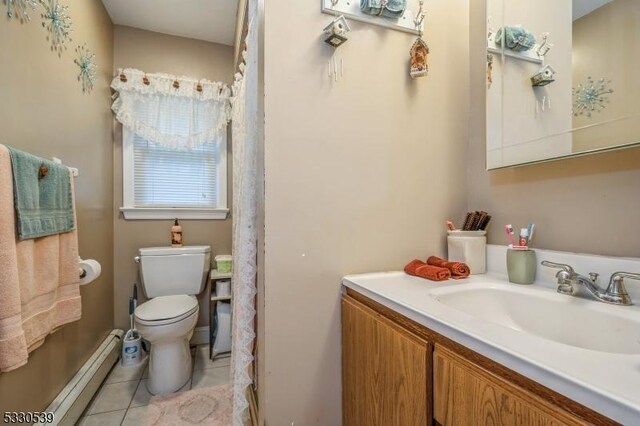 bathroom with baseboard heating, tile patterned floors, vanity, and toilet