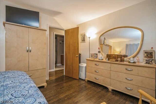 bedroom featuring dark hardwood / wood-style flooring