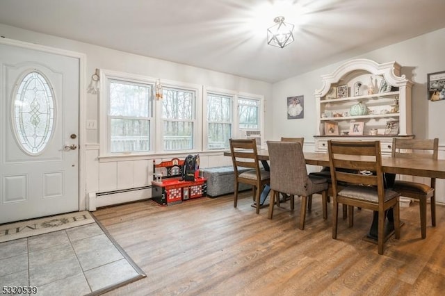 dining area featuring baseboard heating and wood-type flooring