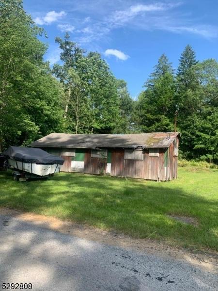 view of outbuilding featuring a yard and a covered pool