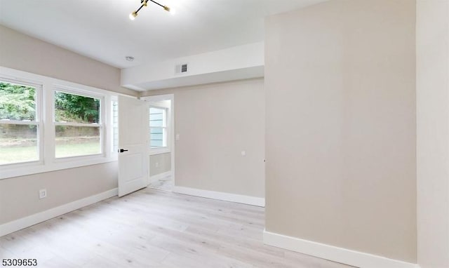 spare room with light hardwood / wood-style floors