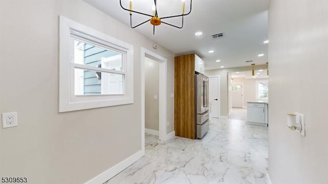 hallway with a chandelier