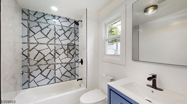 full bathroom with vanity, toilet, and tiled shower / bath