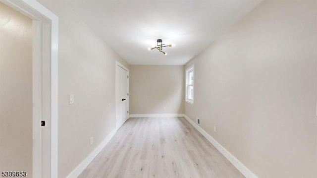 interior space with a notable chandelier and light wood-type flooring