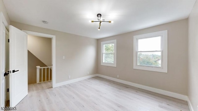 empty room with light hardwood / wood-style flooring