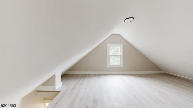 bonus room featuring light hardwood / wood-style floors and vaulted ceiling