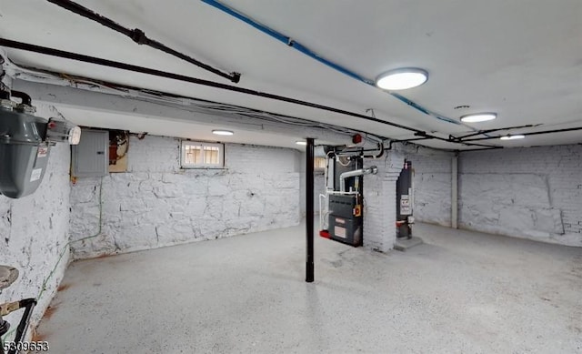 basement with electric panel and water heater