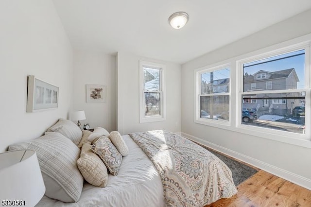 bedroom with wood-type flooring