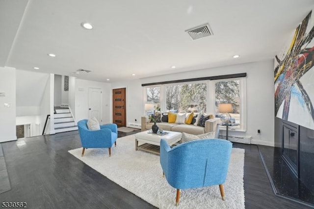 living area with visible vents, stairway, baseboard heating, recessed lighting, and wood finished floors