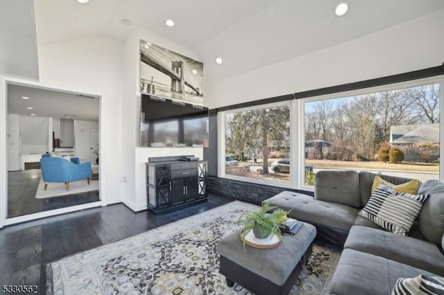 living area with plenty of natural light, recessed lighting, baseboards, and wood finished floors