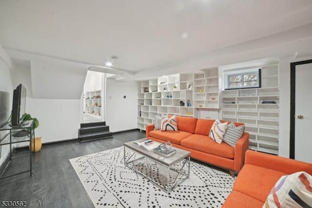 living area with stairway and wood finished floors