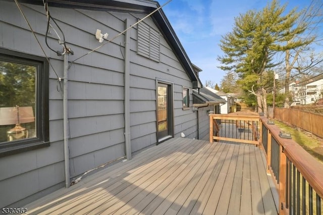 wooden terrace featuring fence